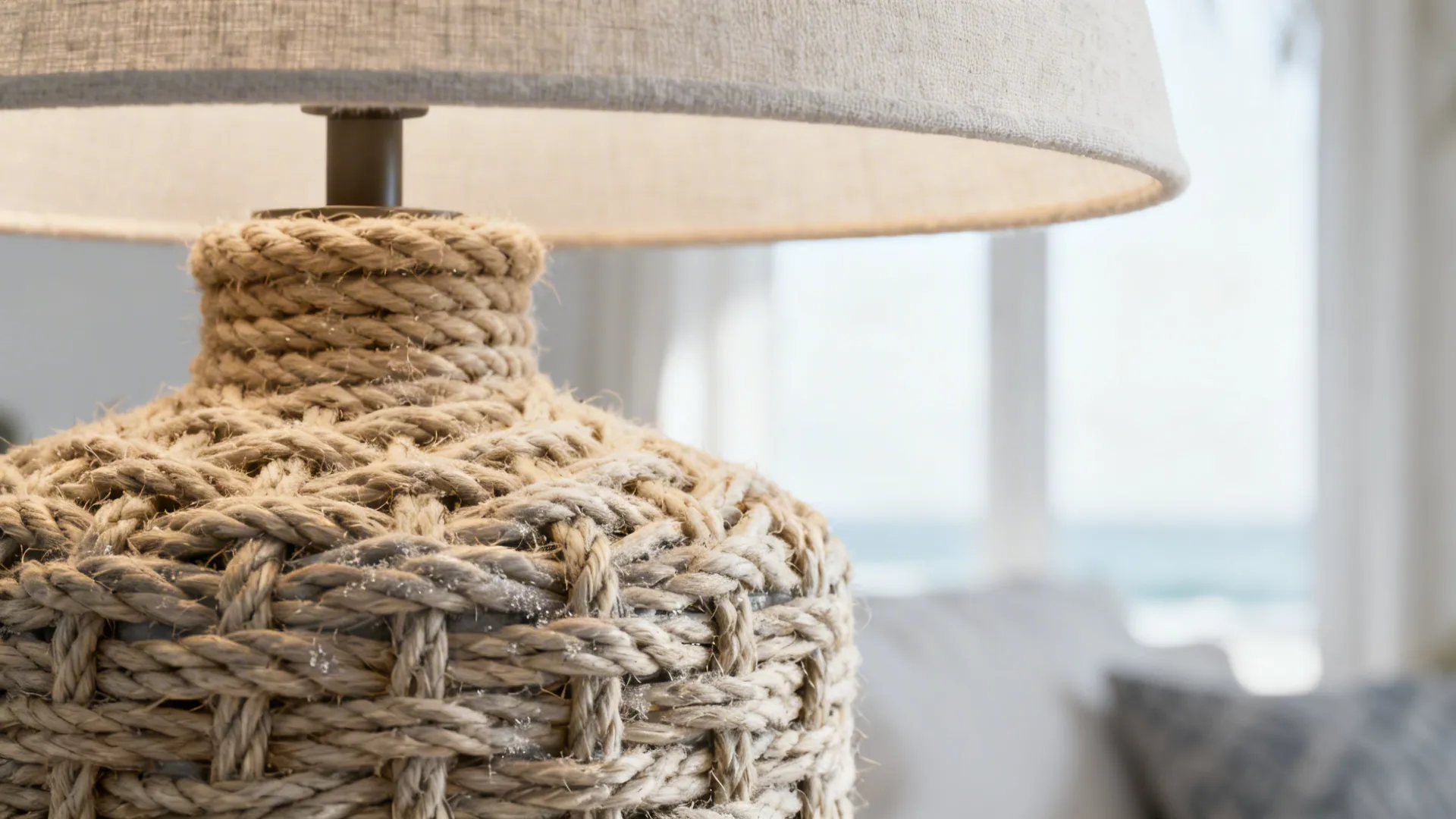 Close-up of a rope-wrapped lamp base with woven texture and neutral shade