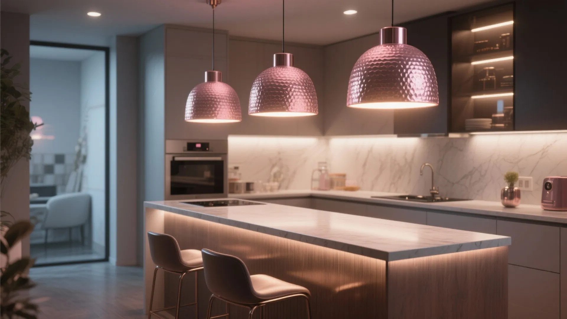 Modern kitchen island with three pink hanging lights marble counters white cabinets and two stools