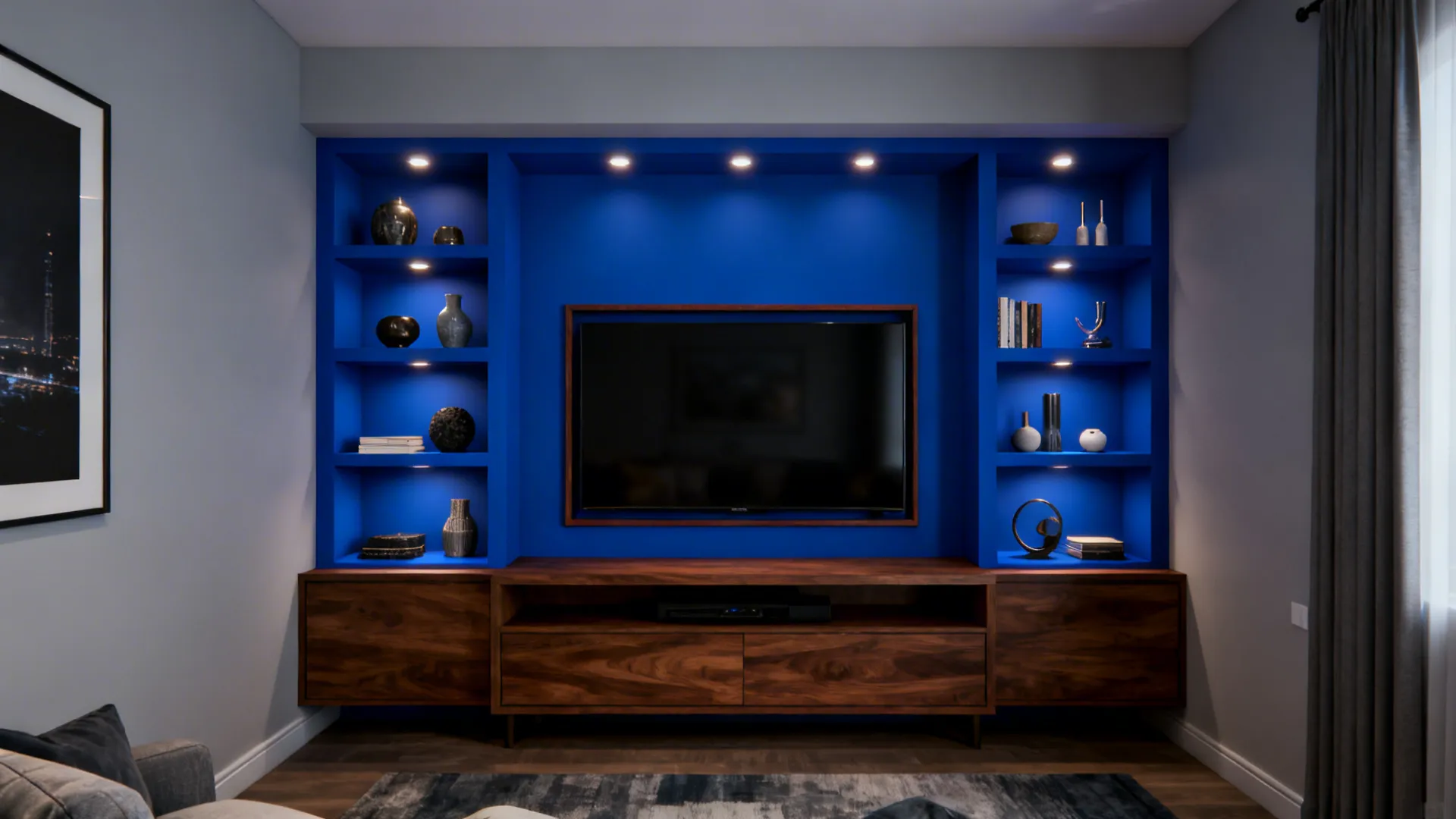 Small living room with a royal blue recessed media wall and pale grey surrounding walls with built-in shelves.