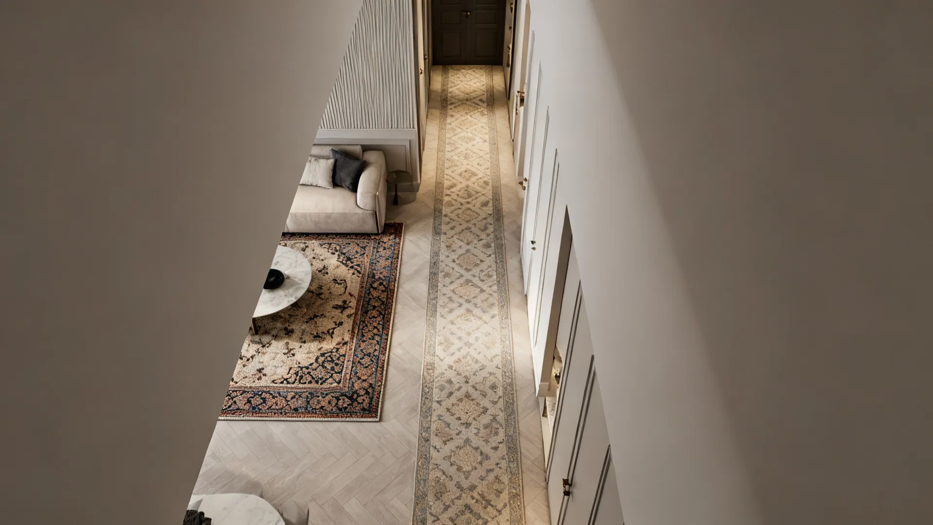 Top-down view of a long apartment with a runner leading to a defined seating area with an area rug.
