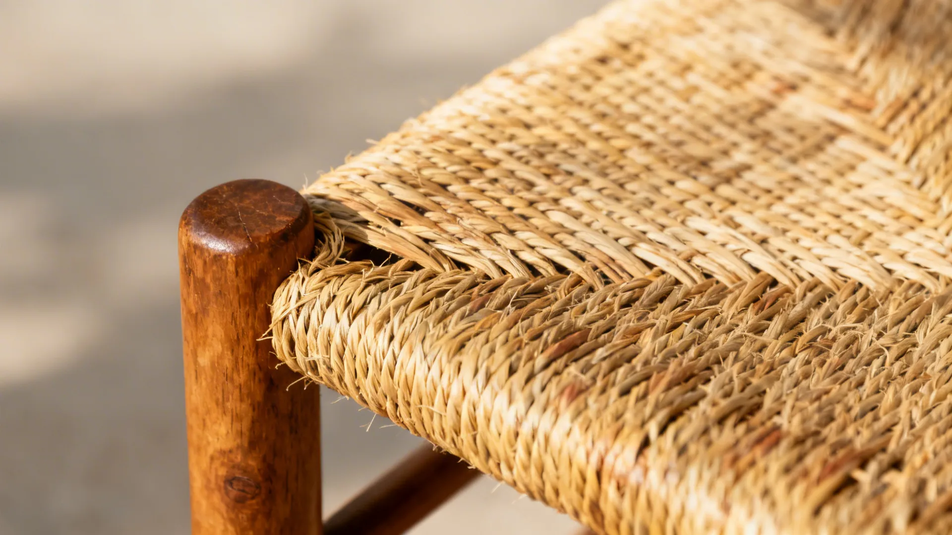 Close-up of rush-seat weaving and patinated oak chair frame.