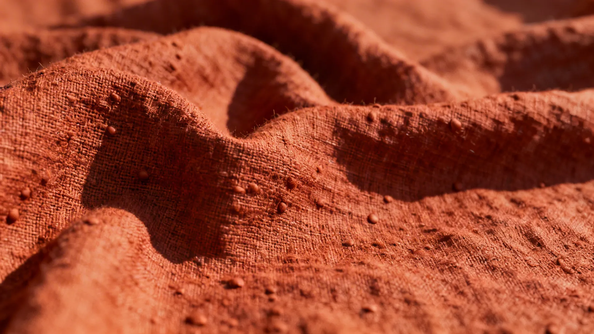 Macro view of slub linen rust fabric showing weave and texture.