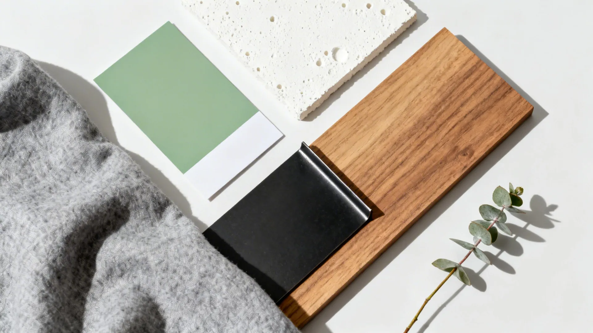 Top-down palette with sage paint, off-white ceiling chip, matte black metal, oak, and grey fabric.