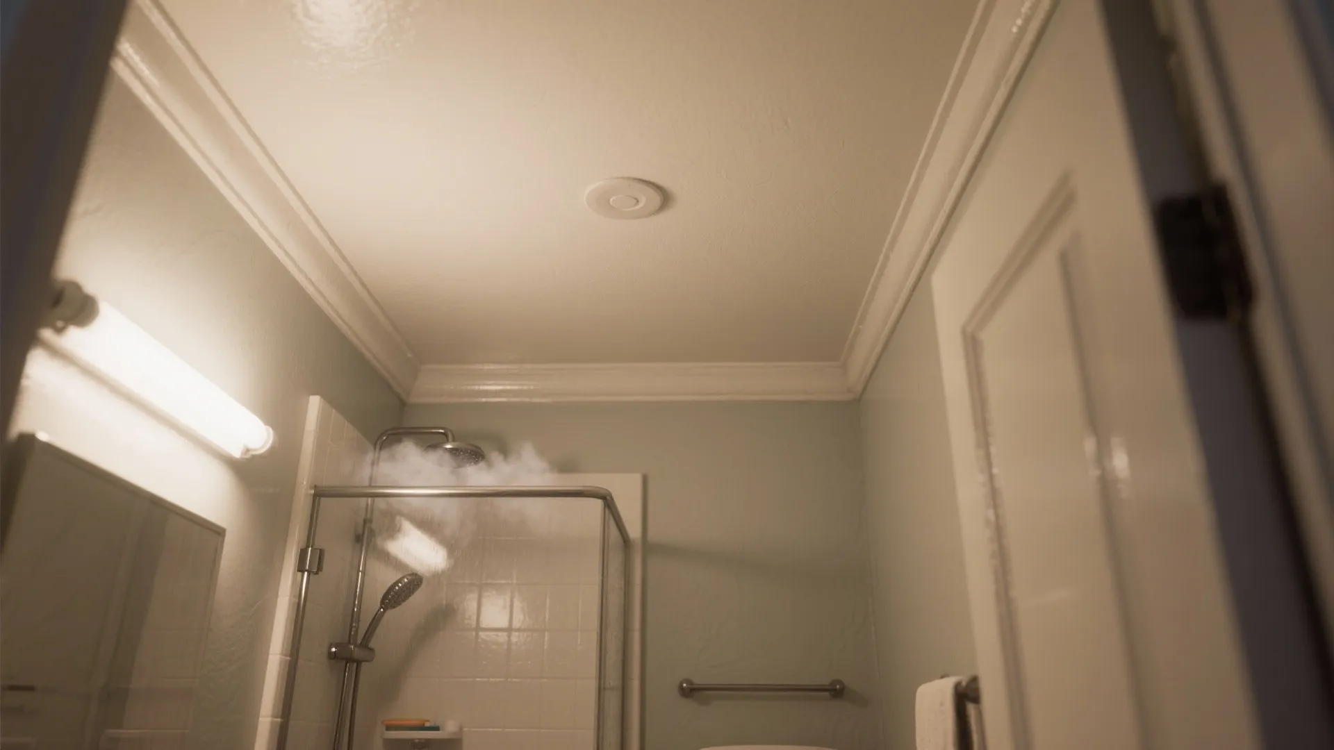 Modern bathroom with white wall panel on ceiling and steam rising from a glass shower