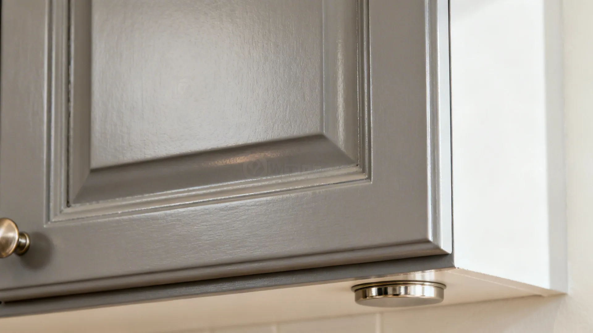 Macro detail of satin enamel on a shaker cabinet corner with soft reflections.