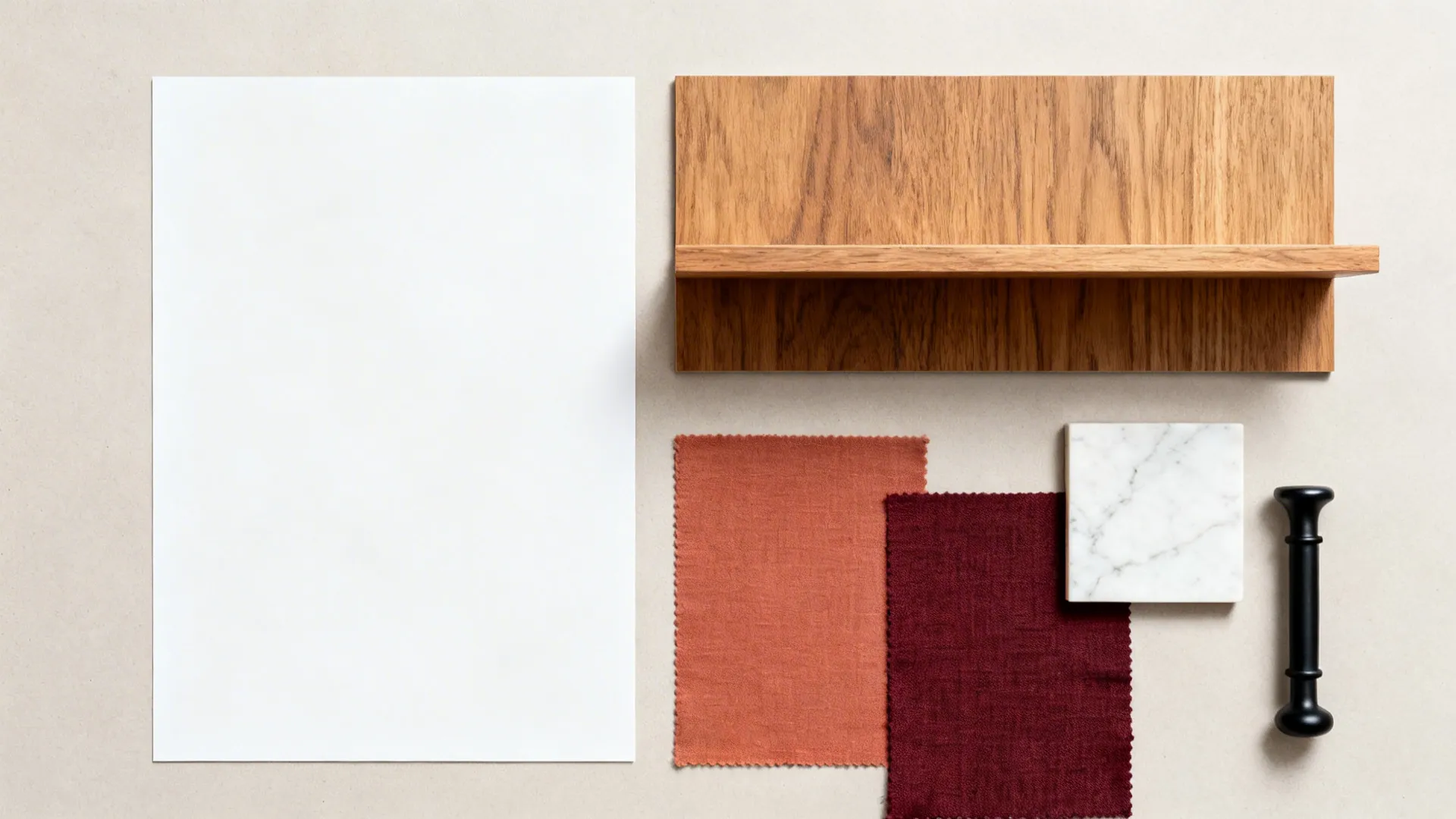 Flat lay of white, oak wood, and muted red textile swatches with quartz and hardware.