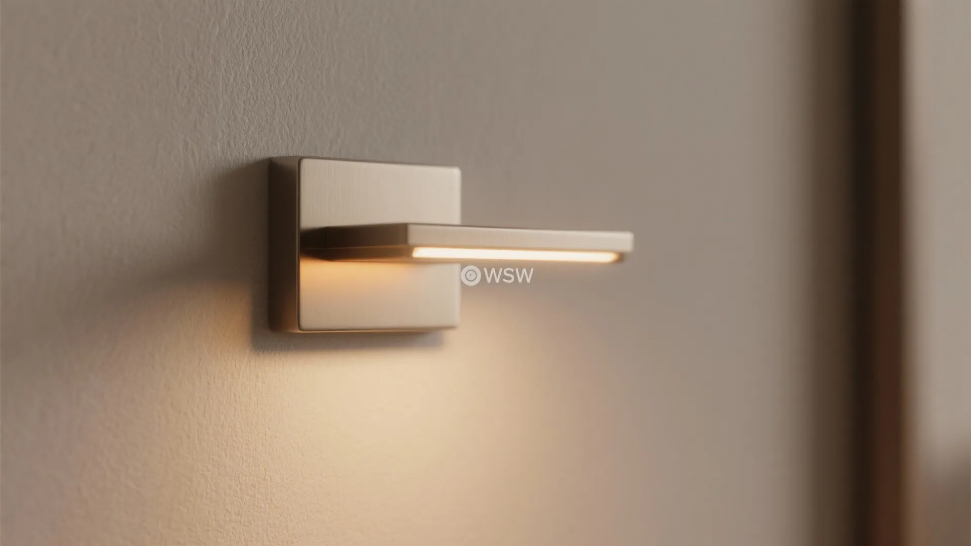 Close up shot of a modern metal wall light fixture shining warm light on the wall