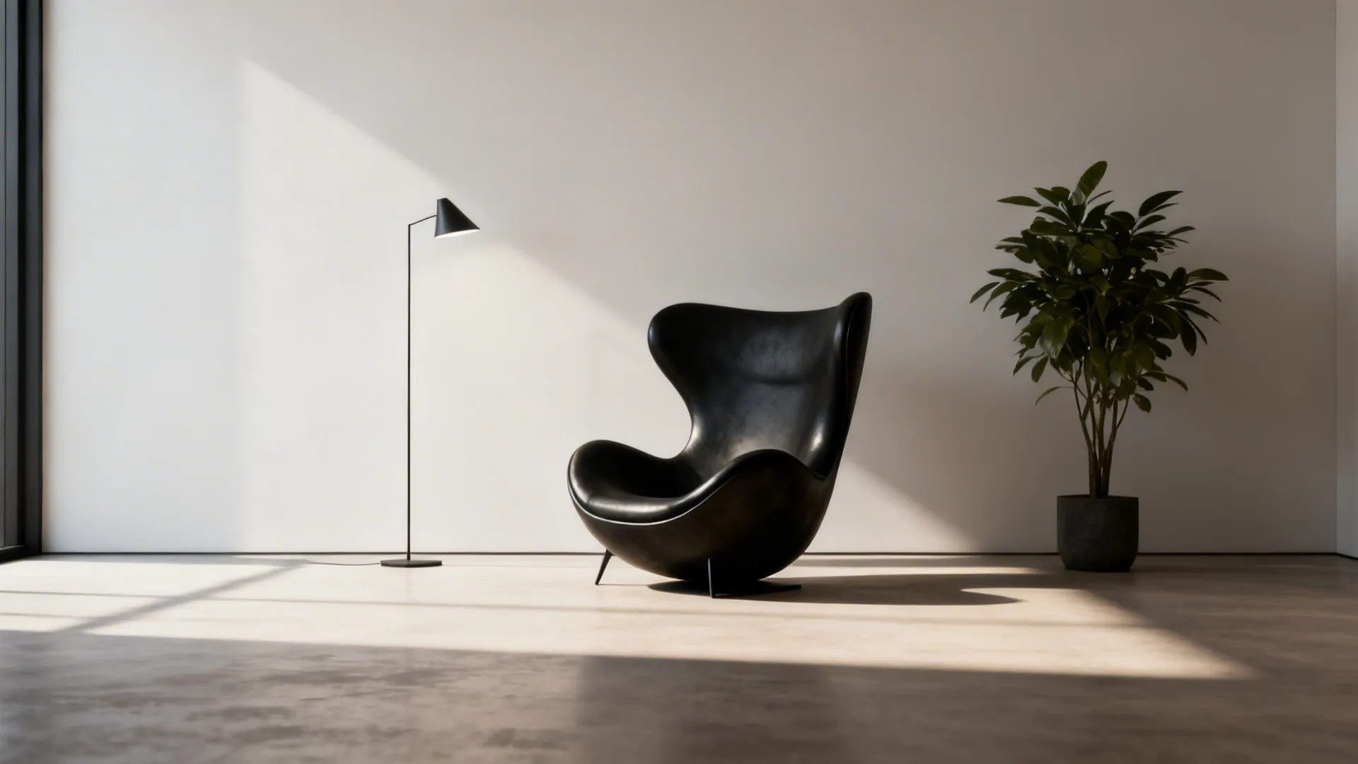Sculptural black armchair placed against a pale wall, serving as a focal art piece.
