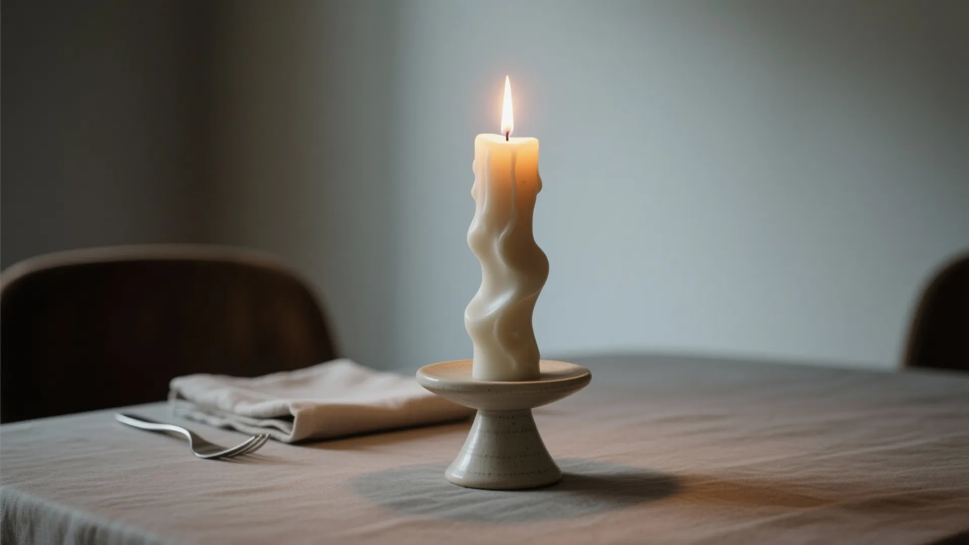 3. A single sculptural candle as a textural focal point