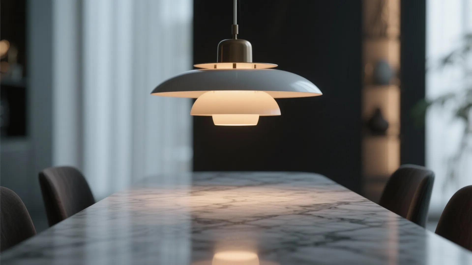 Modern white ceiling light hanging above a marble dining table in a dark room setting