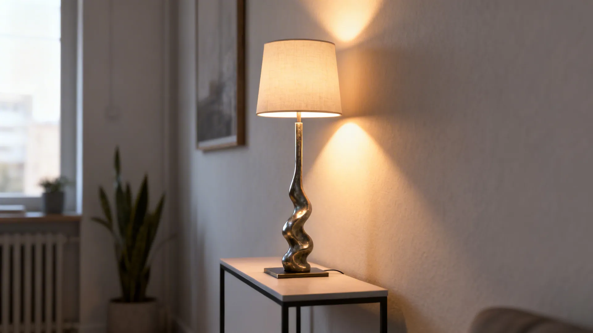 Slim sculptural torchiere lamp on a narrow side table providing ambient uplight in a small living room.