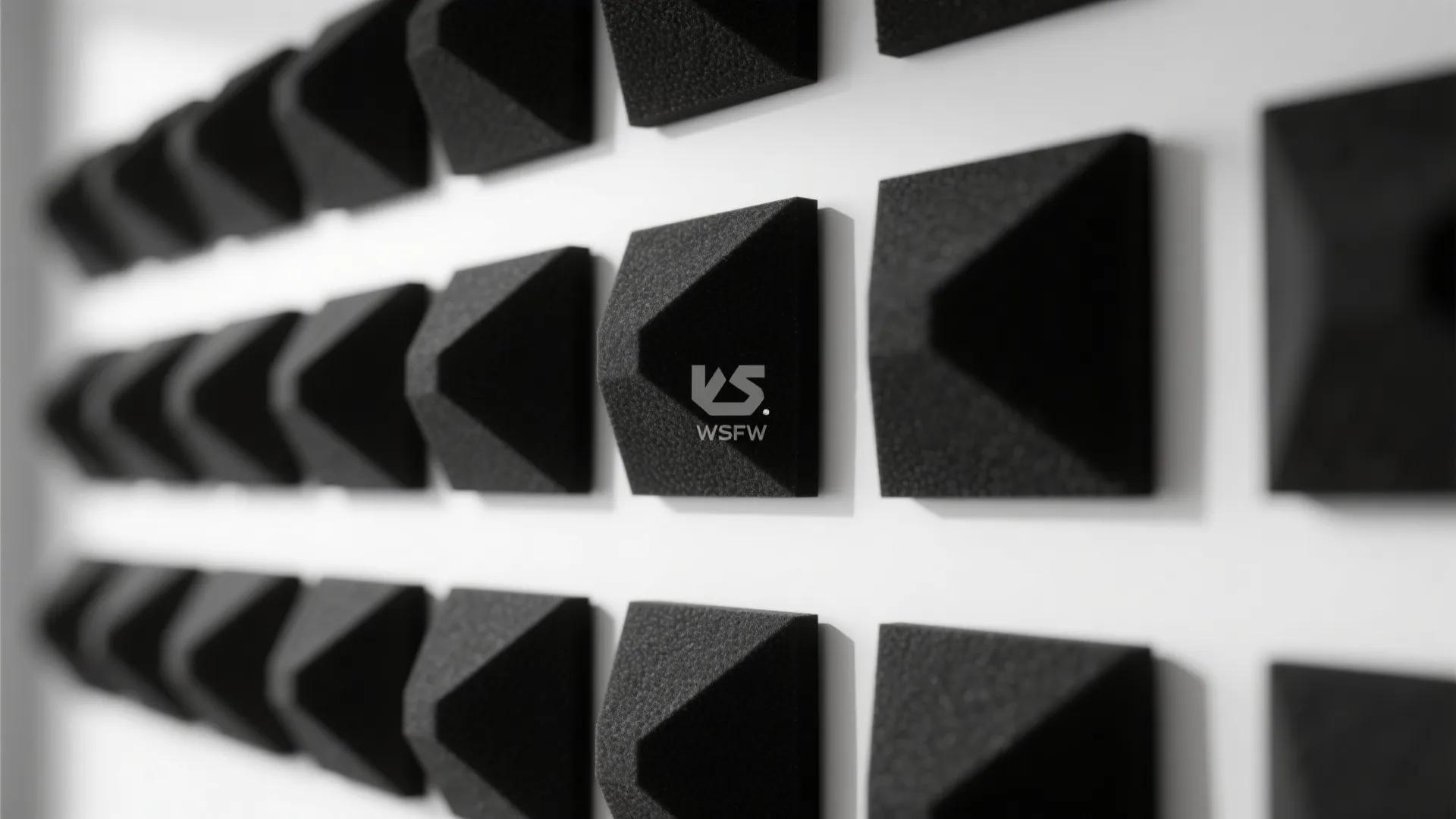 Textured matte black sculptural wall panels in modern decor