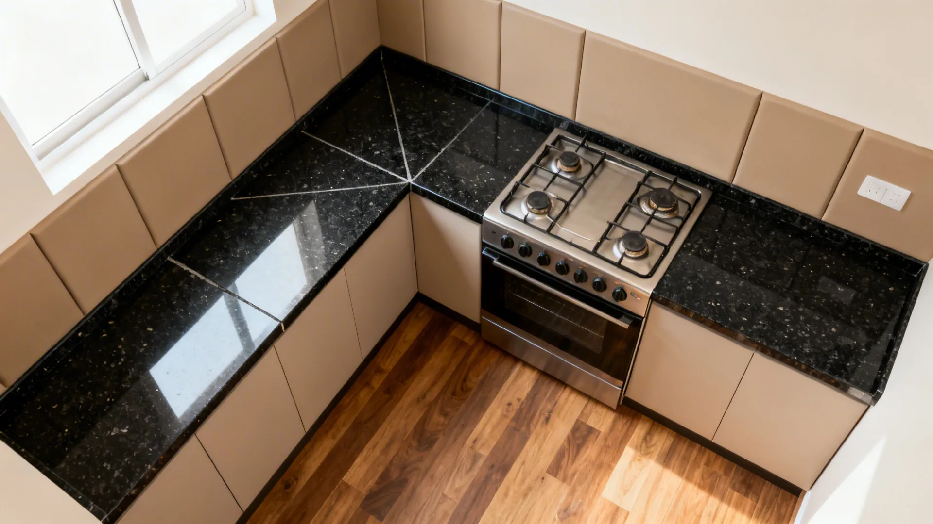 Top-down L-shaped kitchen plan showing seam placement away from the hob and splash zones.