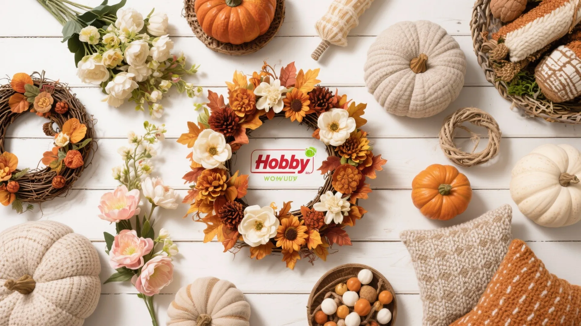 Flatlay of seasonal decor accents including fall wreaths and spring flowers