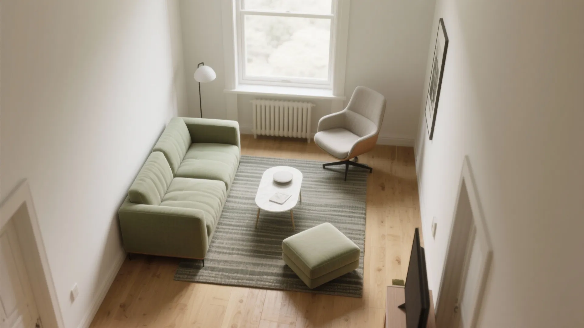 Top view of small living room with green sofa striped rug footrest and large window