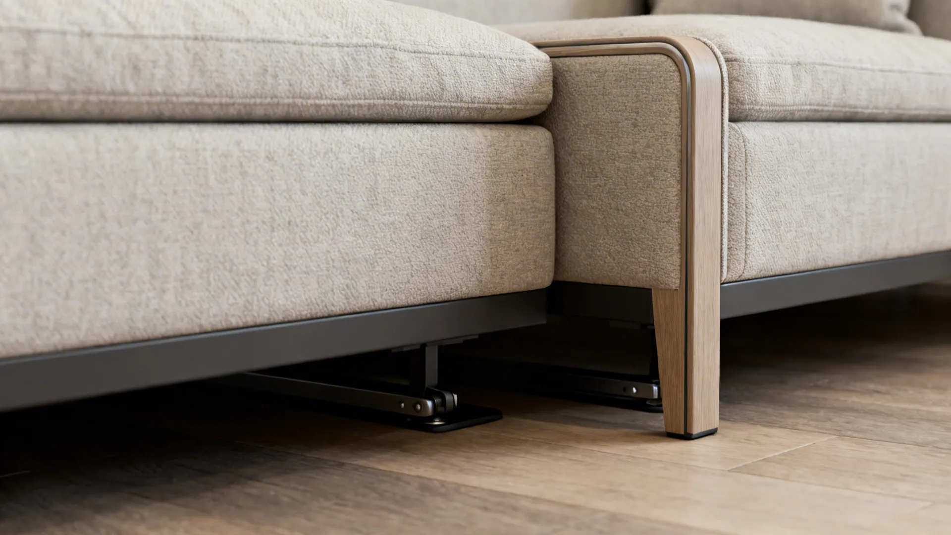 Macro detail of sectional showing exposed legs, slim arms, and hidden glides
