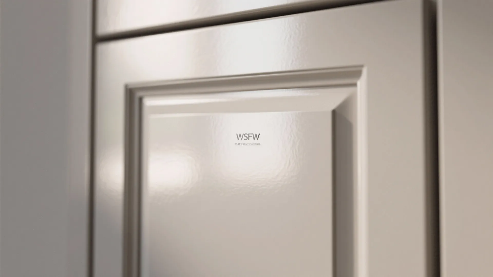 Close up of light grey cabinet with a semi gloss finish reflecting bright indoor light