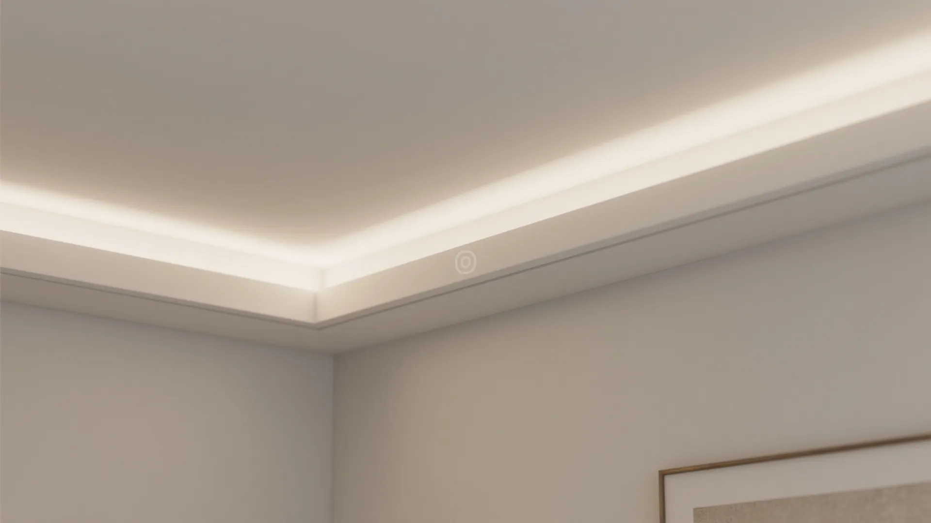 Close up of a room corner showing hidden ceiling light fixture along the white wall