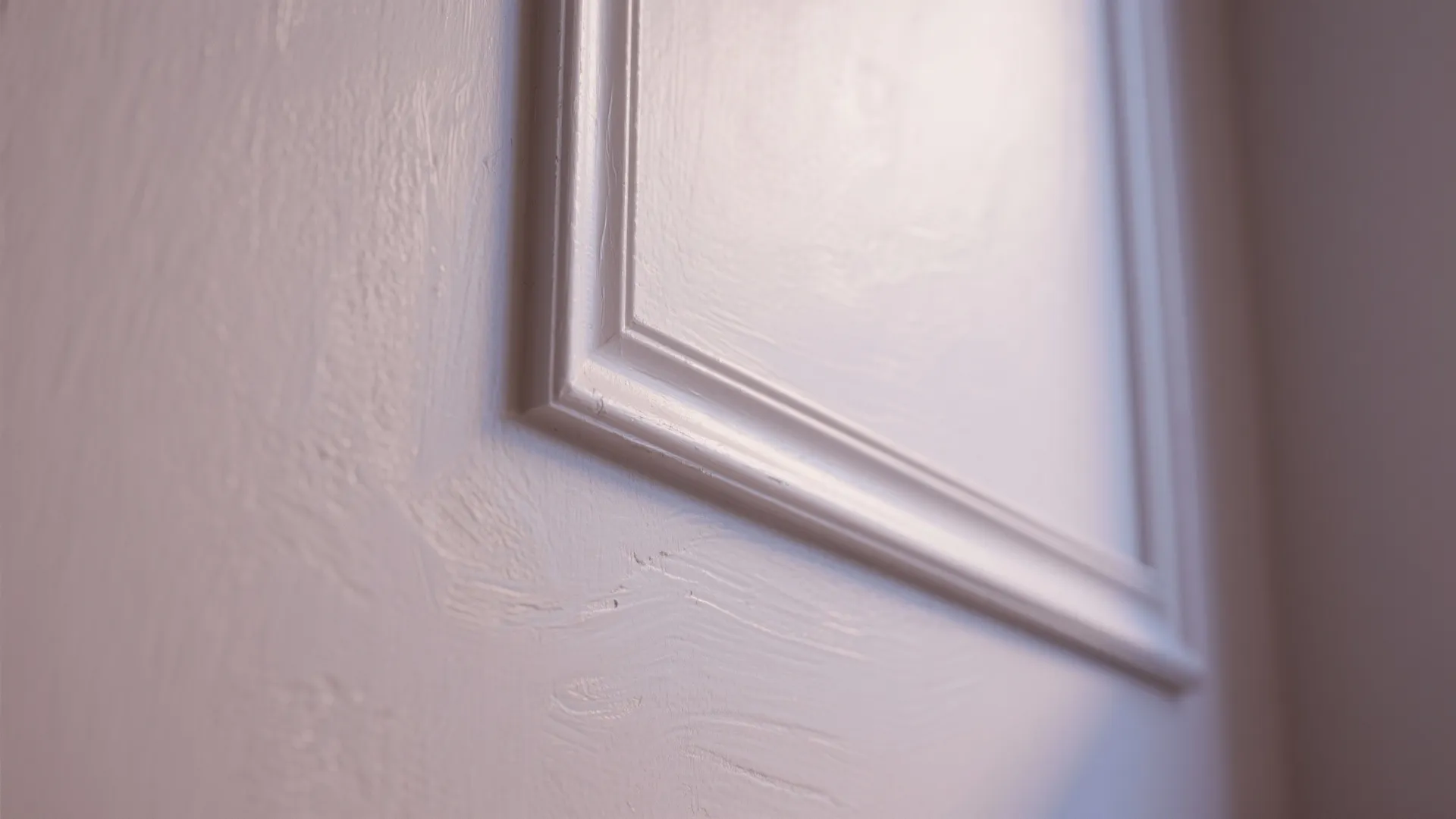 Close up of white wall panel with decorative molding showing light and shadows on surface