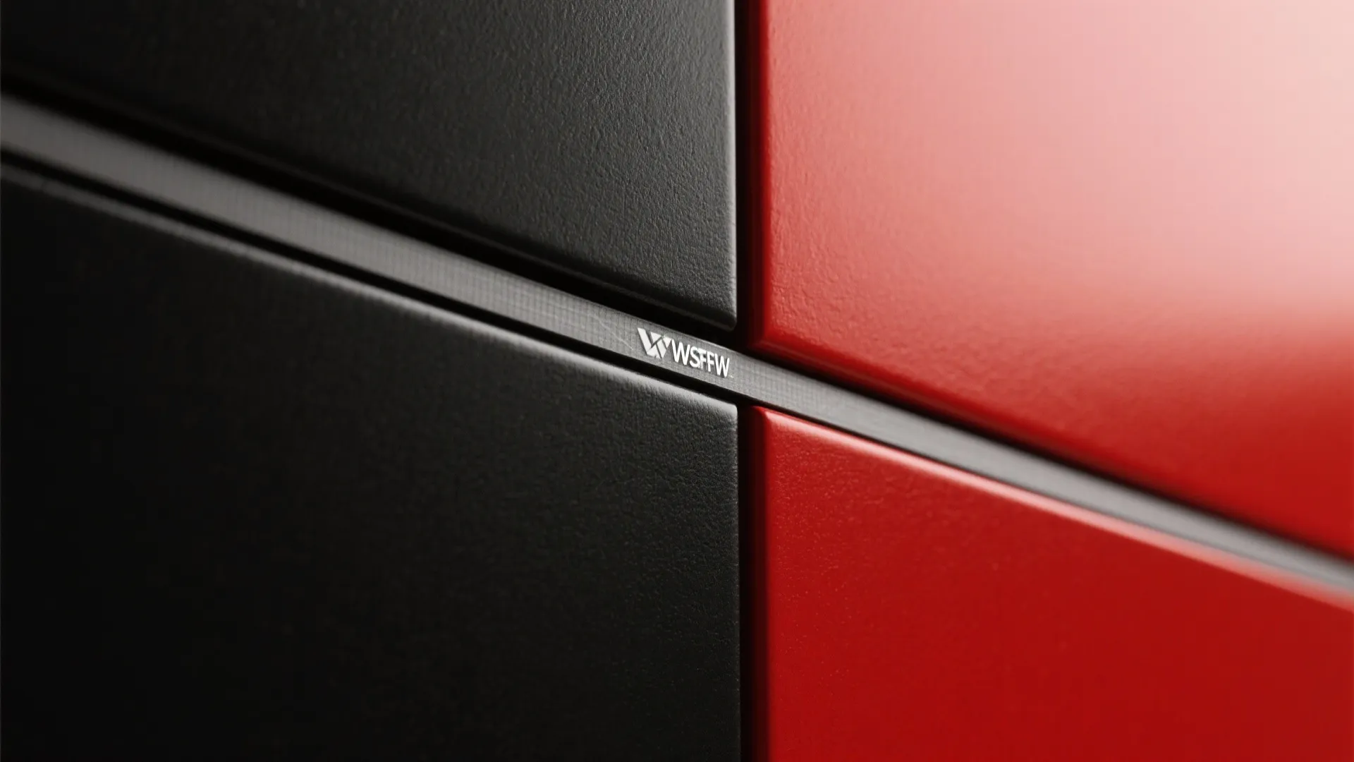 Close up of red and black textured wall panels with a small white brand logo