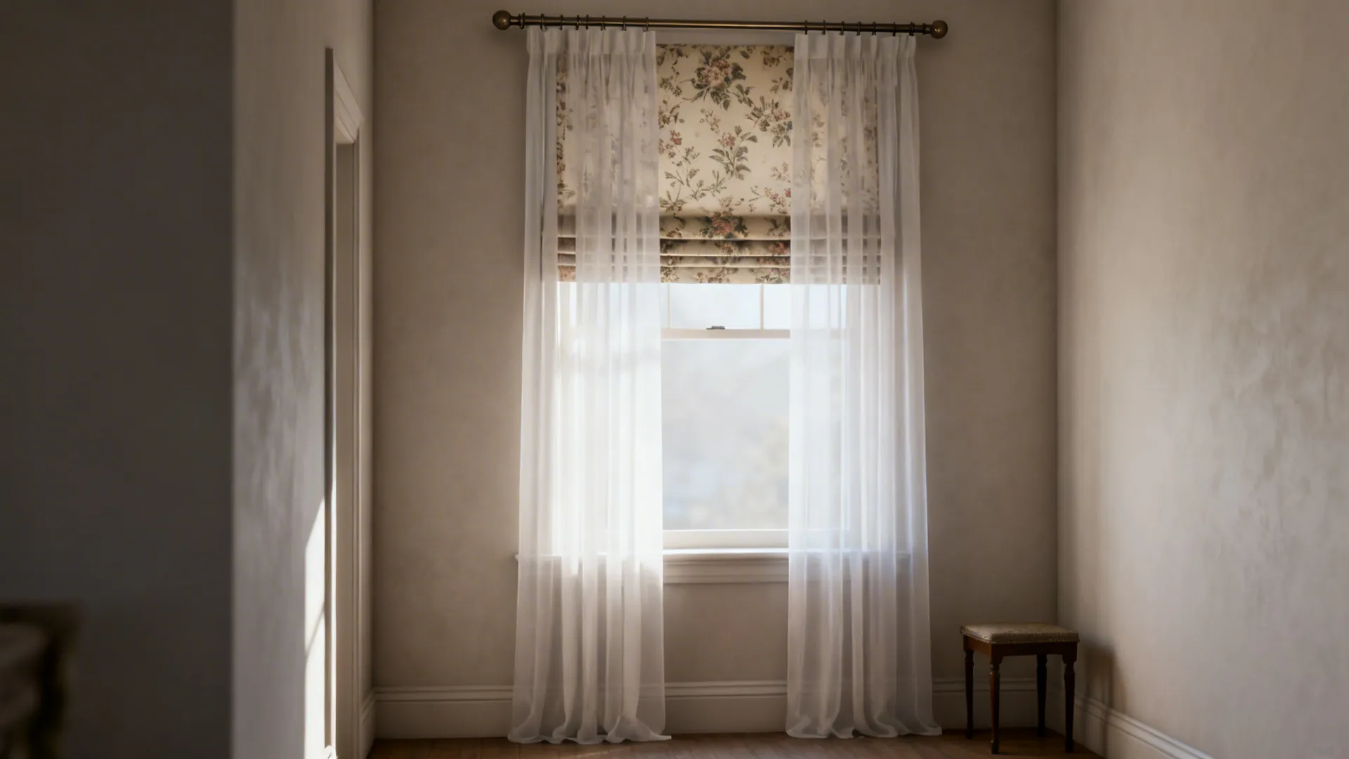 Narrow living room window with a sheer layer over a vintage-patterned Roman shade.