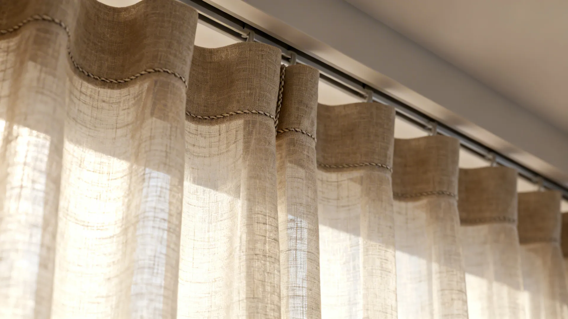 Close-up of semi-sheer floor-to-ceiling curtain fabric and concealed track with diffused daylight.