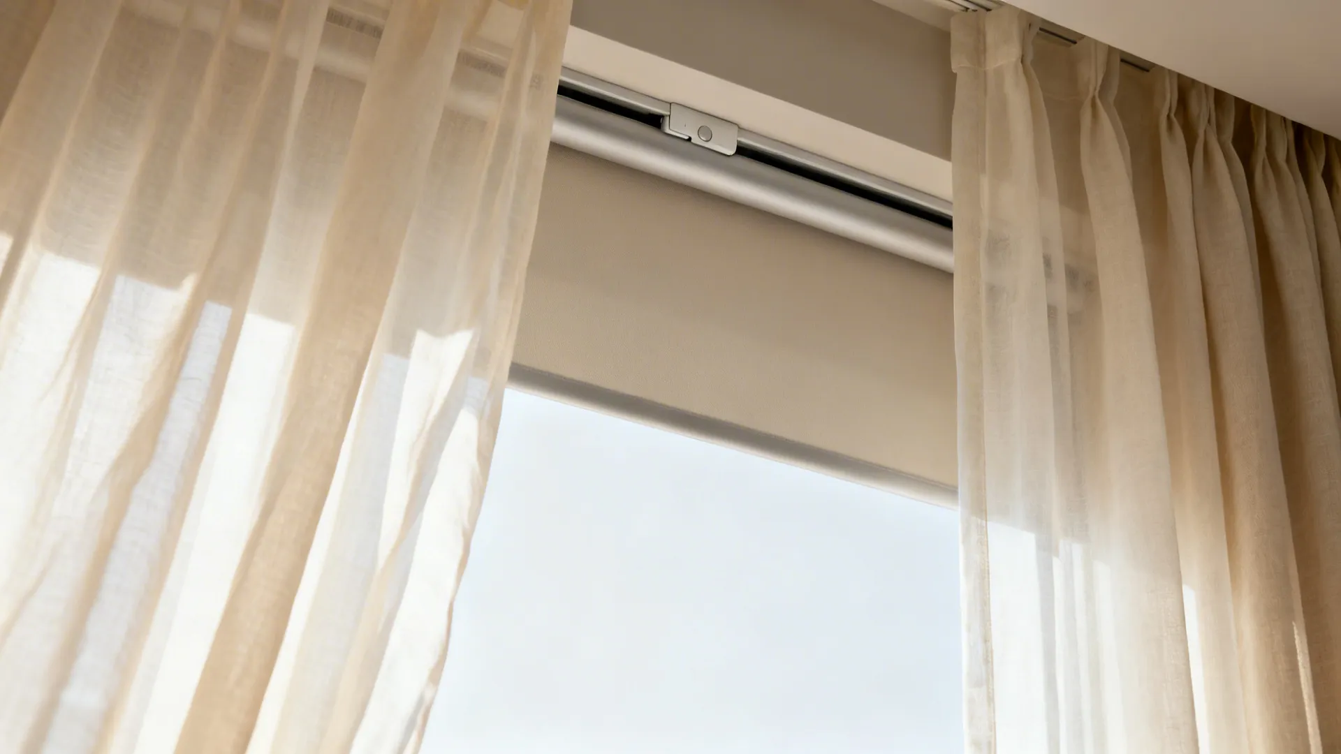 Layered sheer curtain and hidden roller shade showing fabric texture and clean modern mounting.