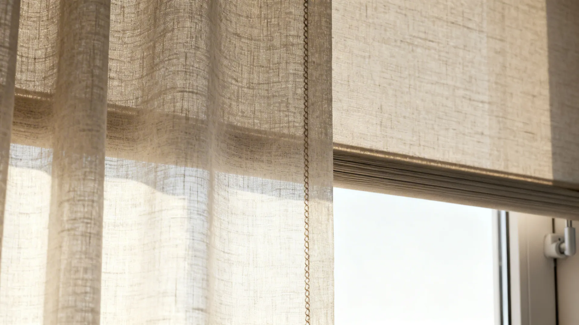 Close-up of linen sheer curtain layered over a concealed roller shade with soft daylight.