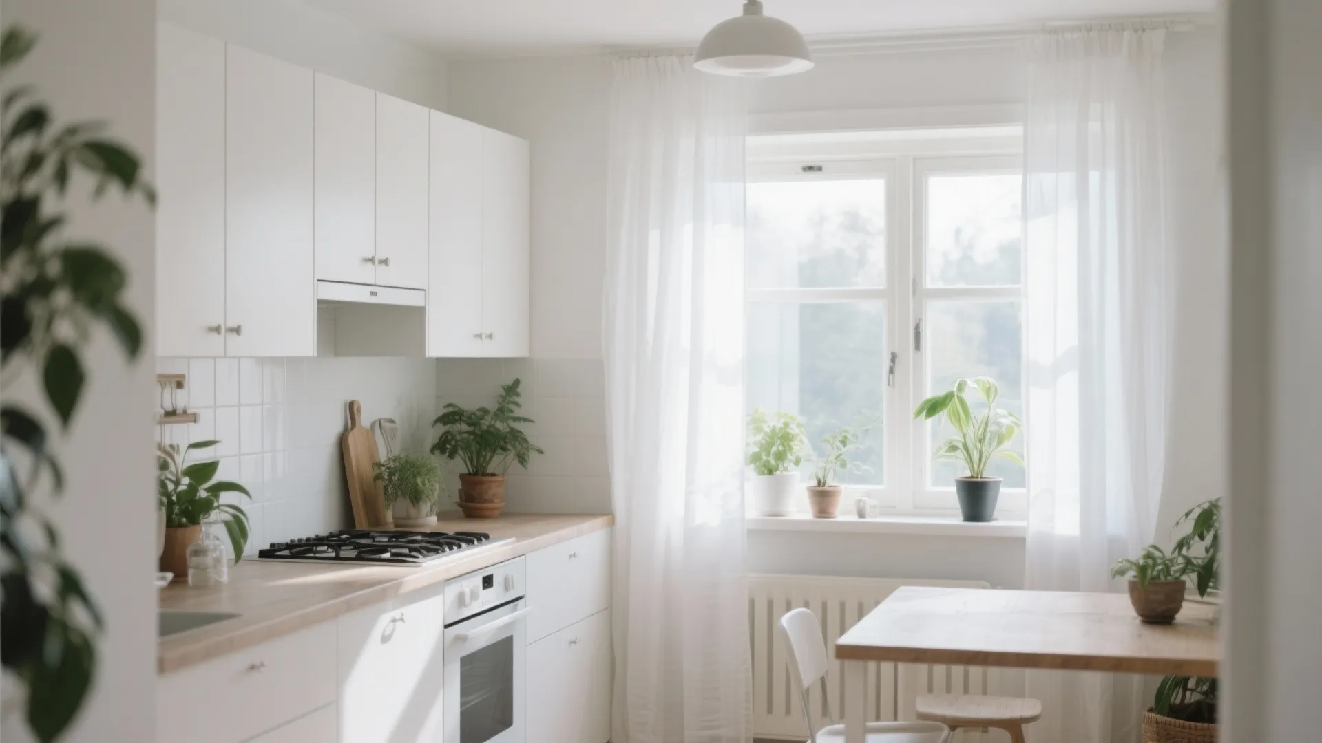 Sheer white curtains creating an airy Scandinavian kitchen