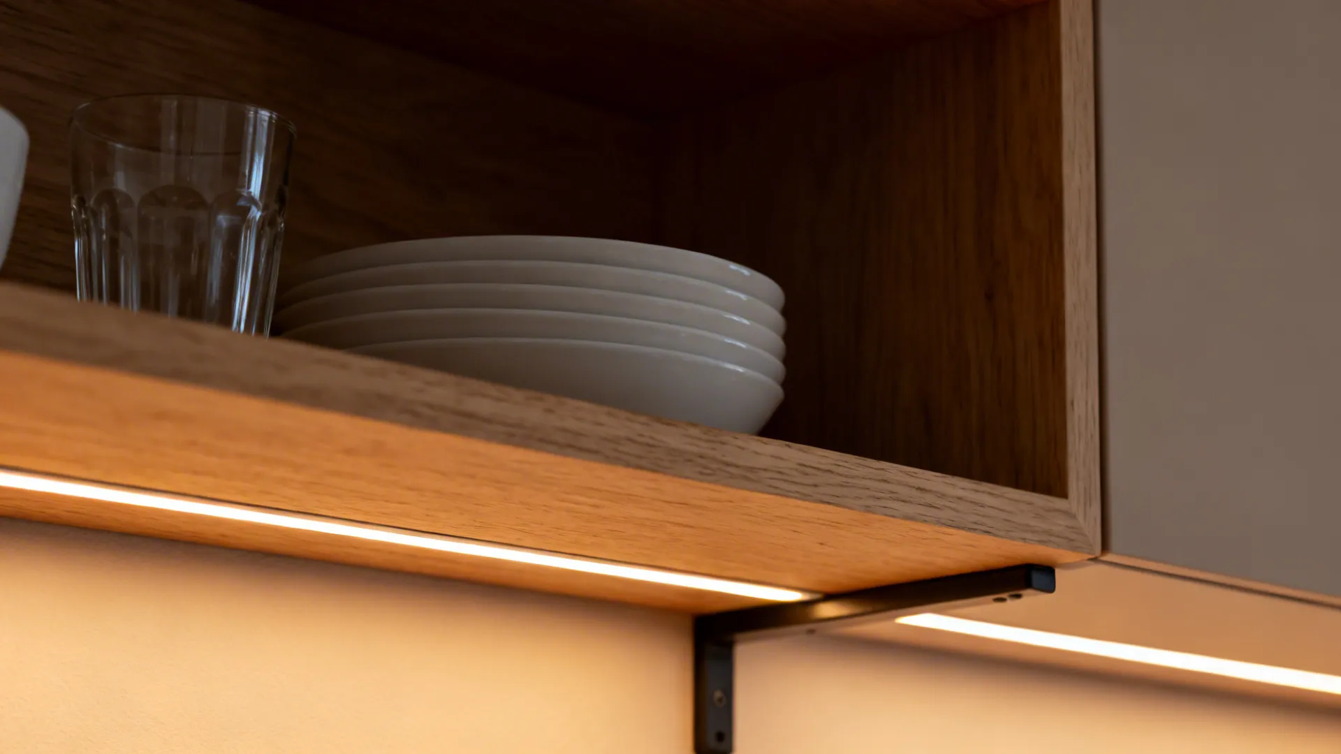 Macro of wood grain and LED-lit open kitchen shelf with stacked white bowls.