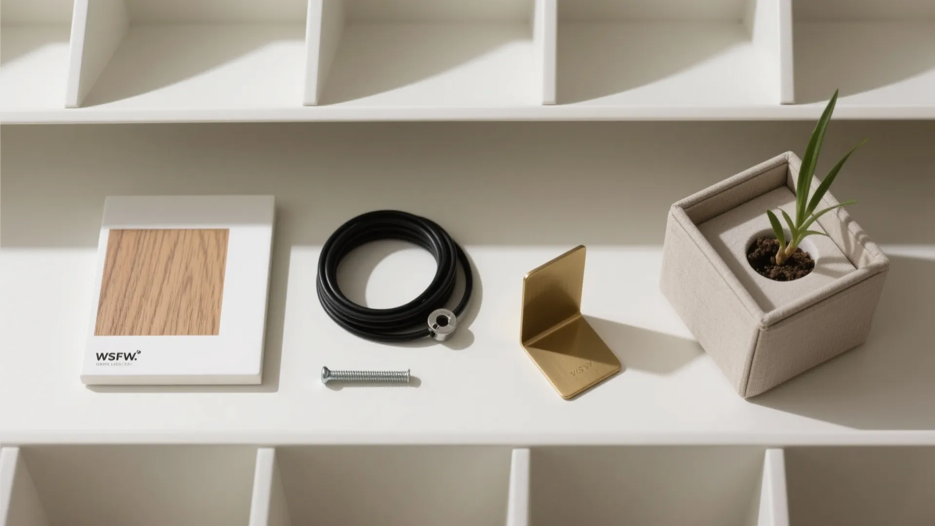White shelf displaying wood sample black cable metal bracket small screw and small green potted plant