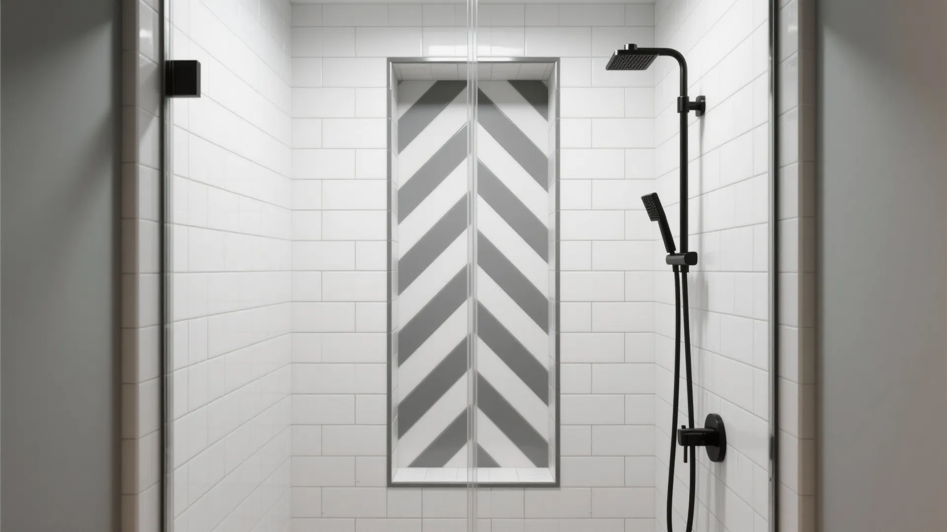 White tiled shower with black shower head and grey patterned wall shelf for simple bathroom storage