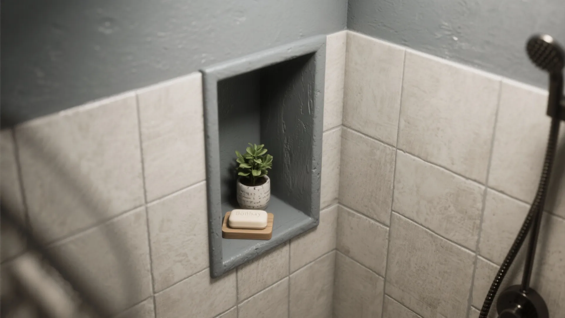 A gray wall niche in a tiled shower holding a small green plant and soap bar