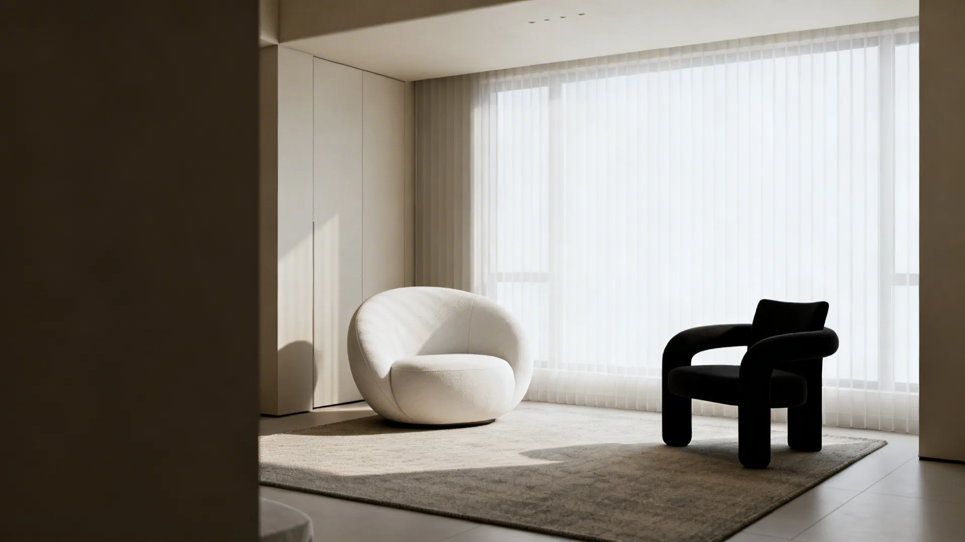 Compact living room with rounded-back white chair and sculptural black chair showing balanced scale and silhouette.
