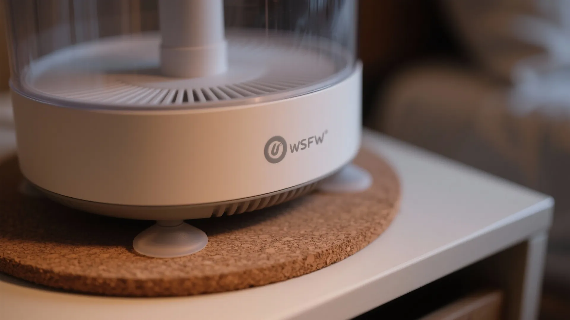 Close-up of silicone-isolated humidifier feet resting on a cork mat.