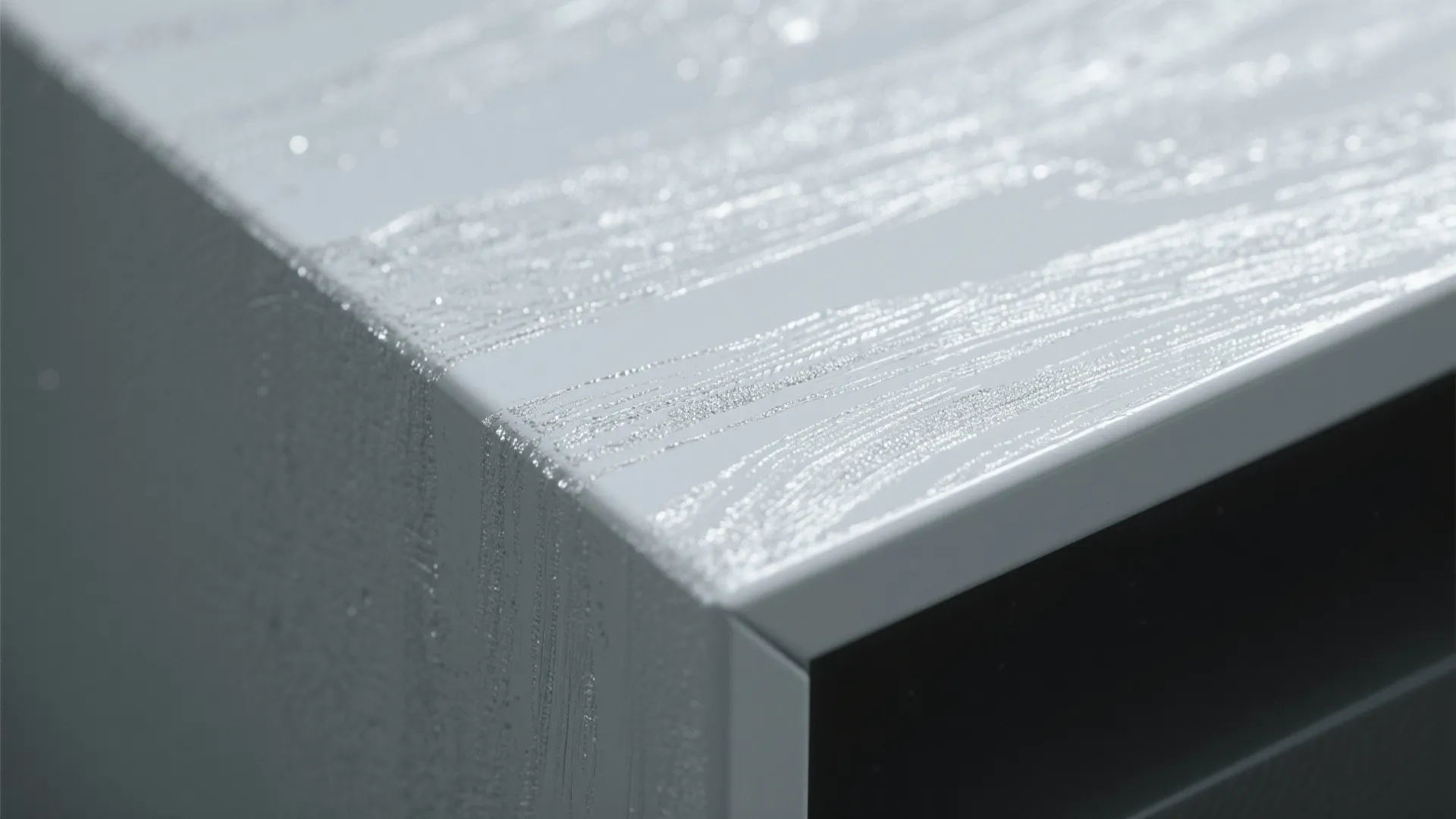 Close up of white cabinet corner with a textured surface reflecting bright natural indoor light