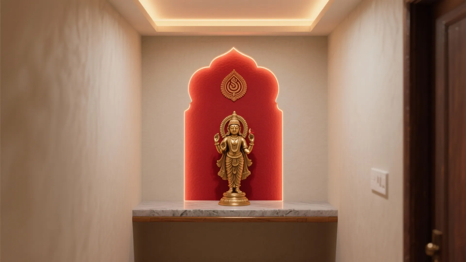 Golden statue placed in a red wall niche with marble shelf and warm ceiling light