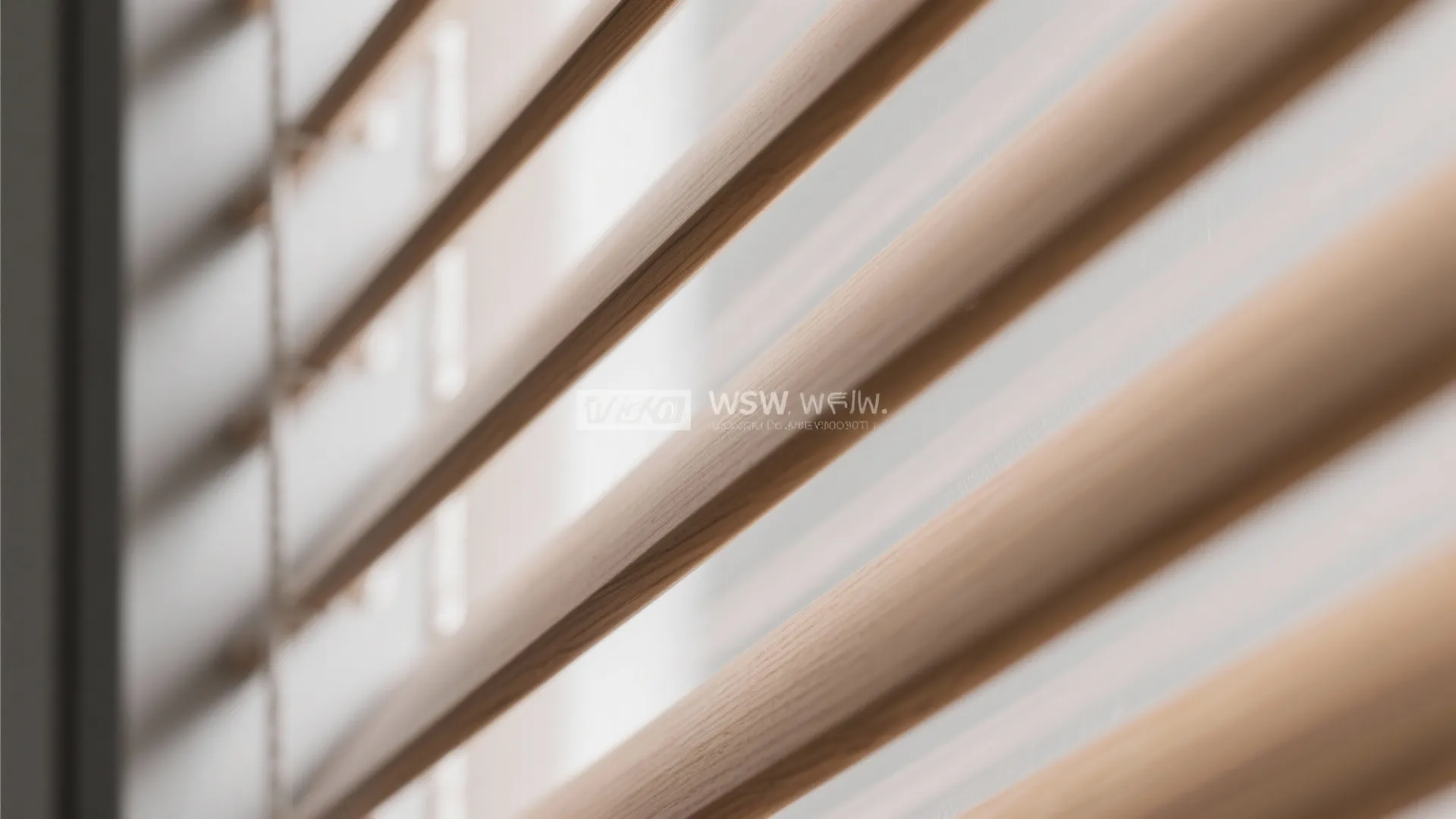 Close up view of wooden window blinds showing thin slats and natural light in room
