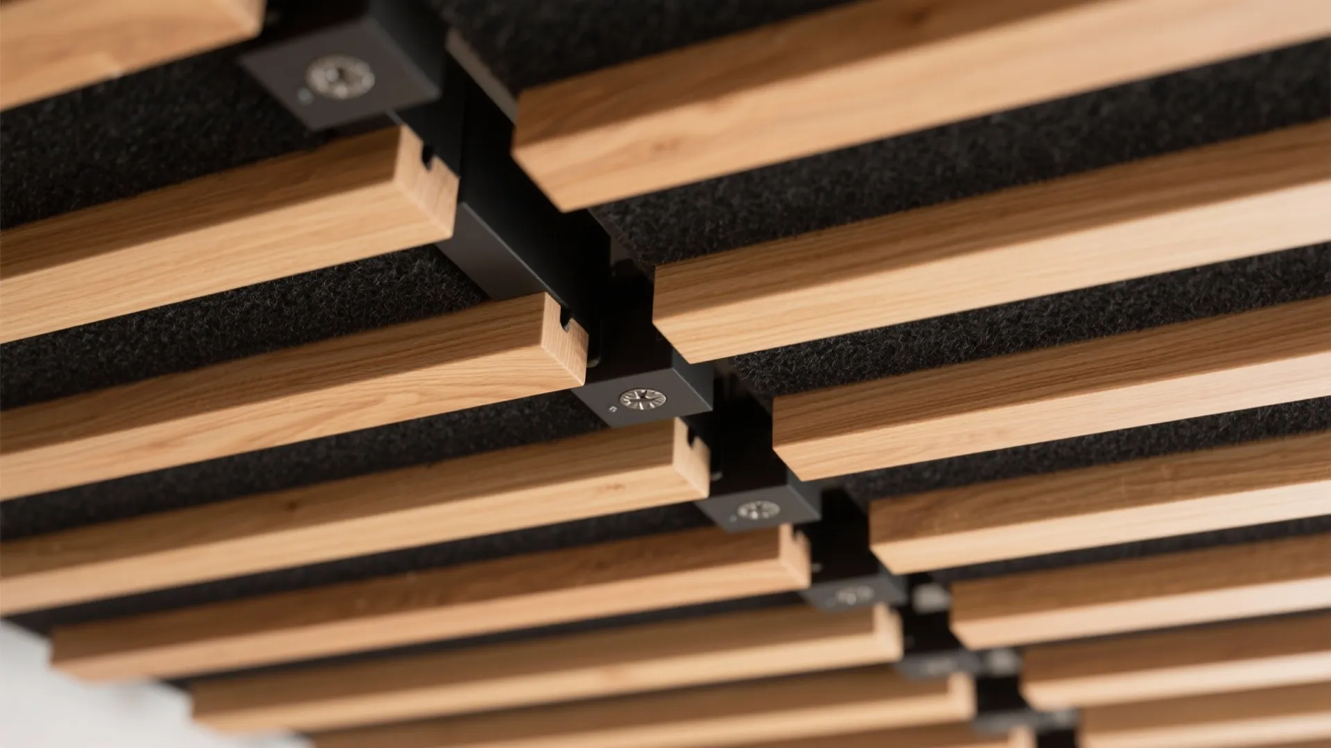 Close up view of wooden ceiling slats with small black ceiling light fixtures and background