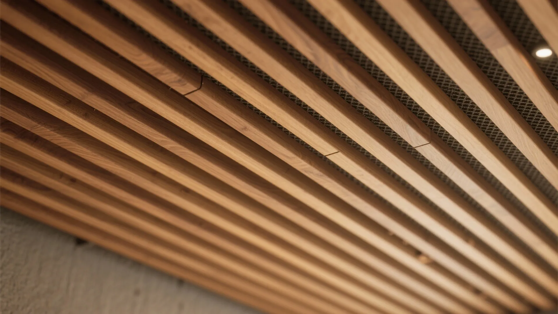 Close up view of parallel wooden slats on a ceiling with small round light fixtures