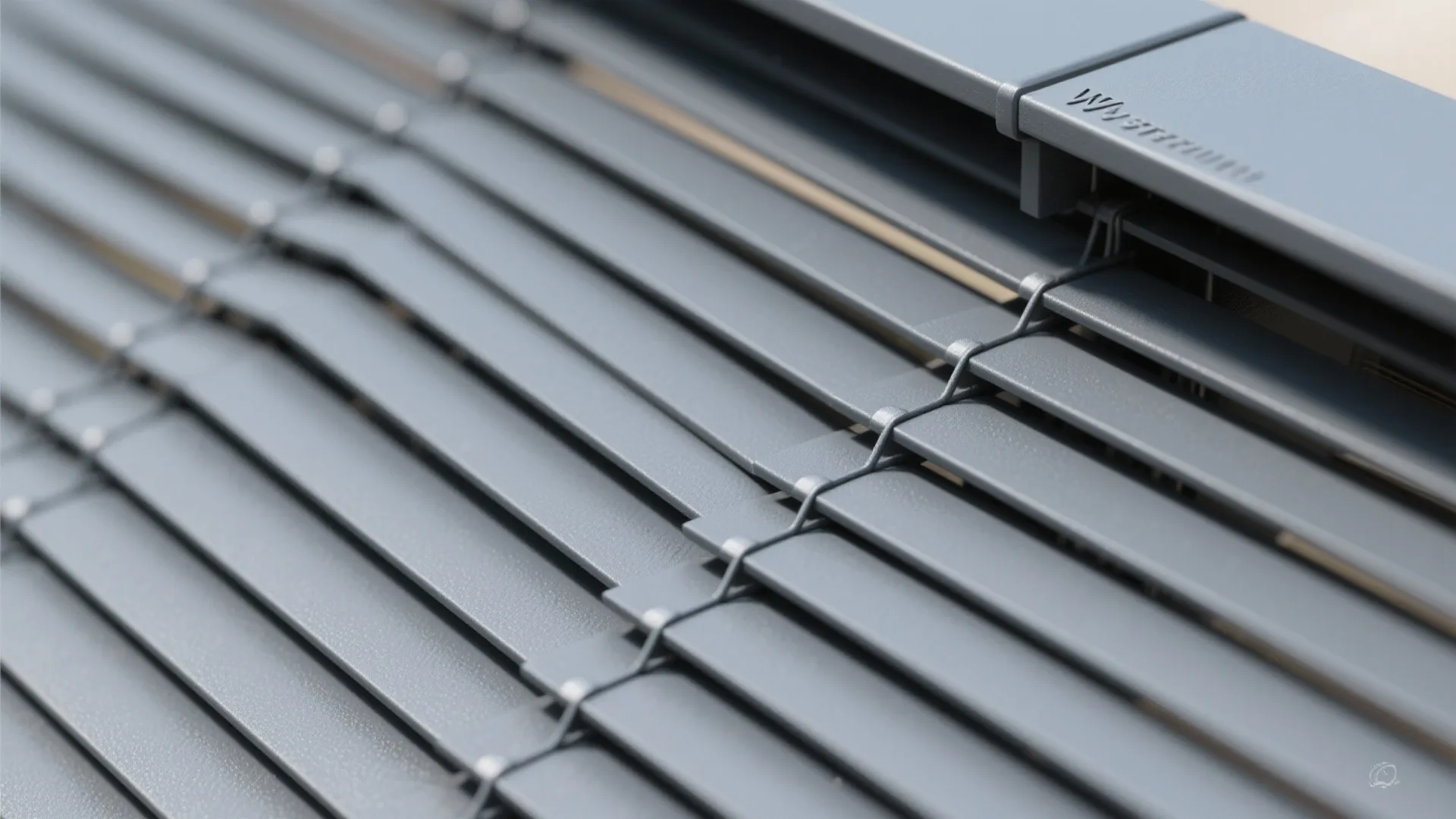 Macro of matte powder-coated aluminum slats with precise spacing and clean joint.