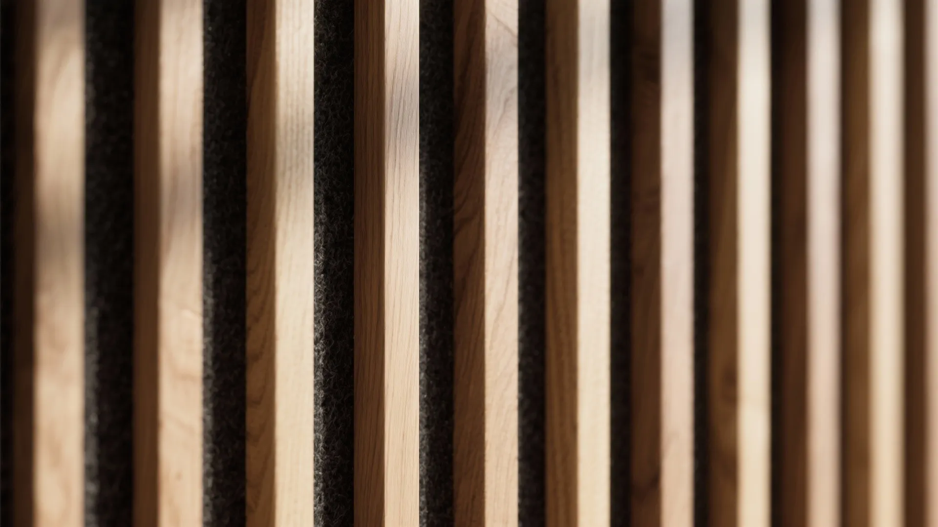 Close up view of vertical wooden wall panel slats with grey fabric background and soft shadows