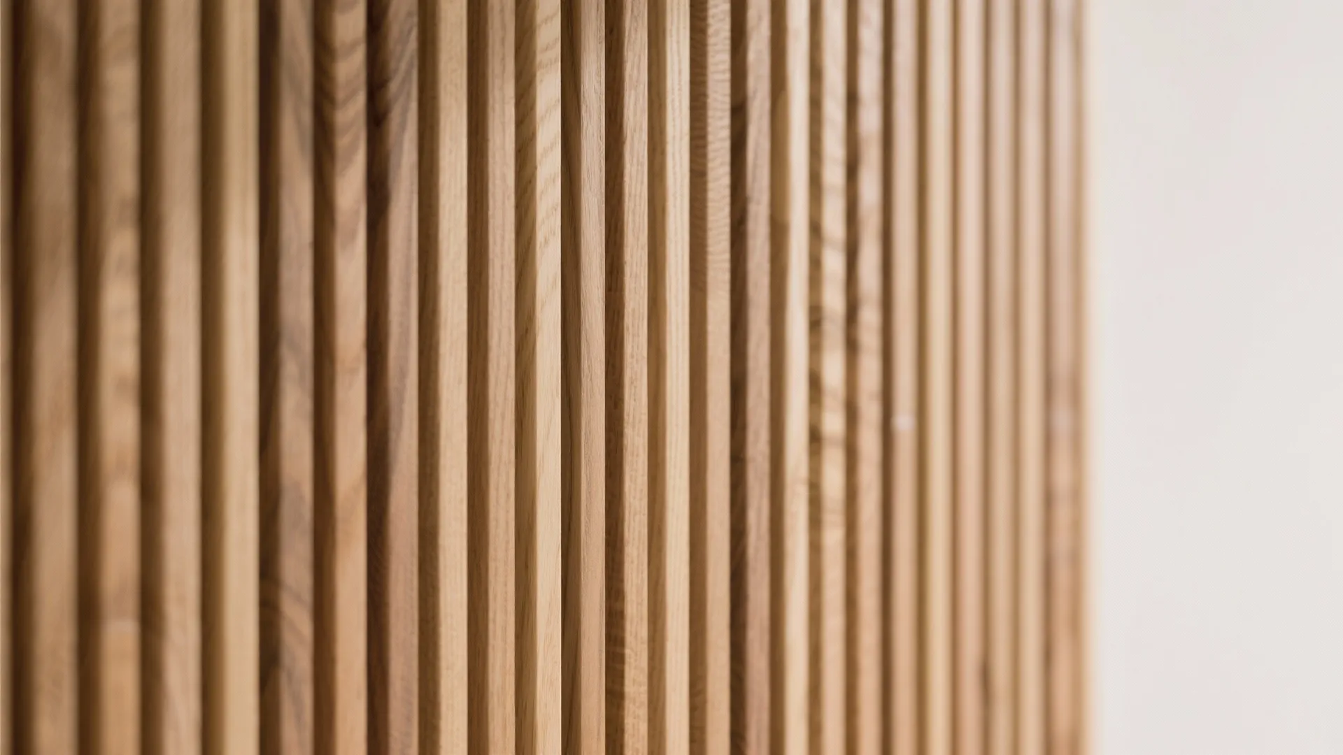 Close-up of oak slat divider showing grain and soft shadows.