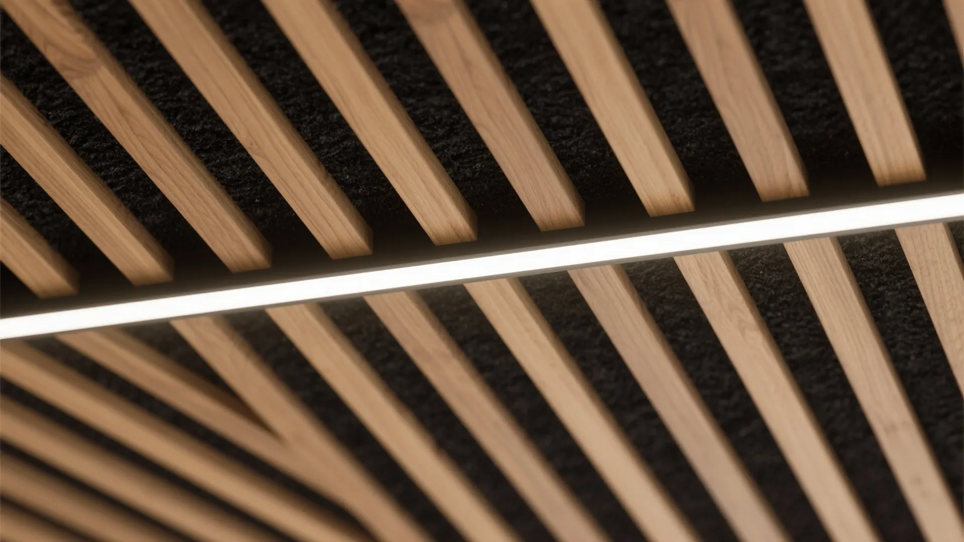Macro of wood slats over black felt with a centered linear LED channel.