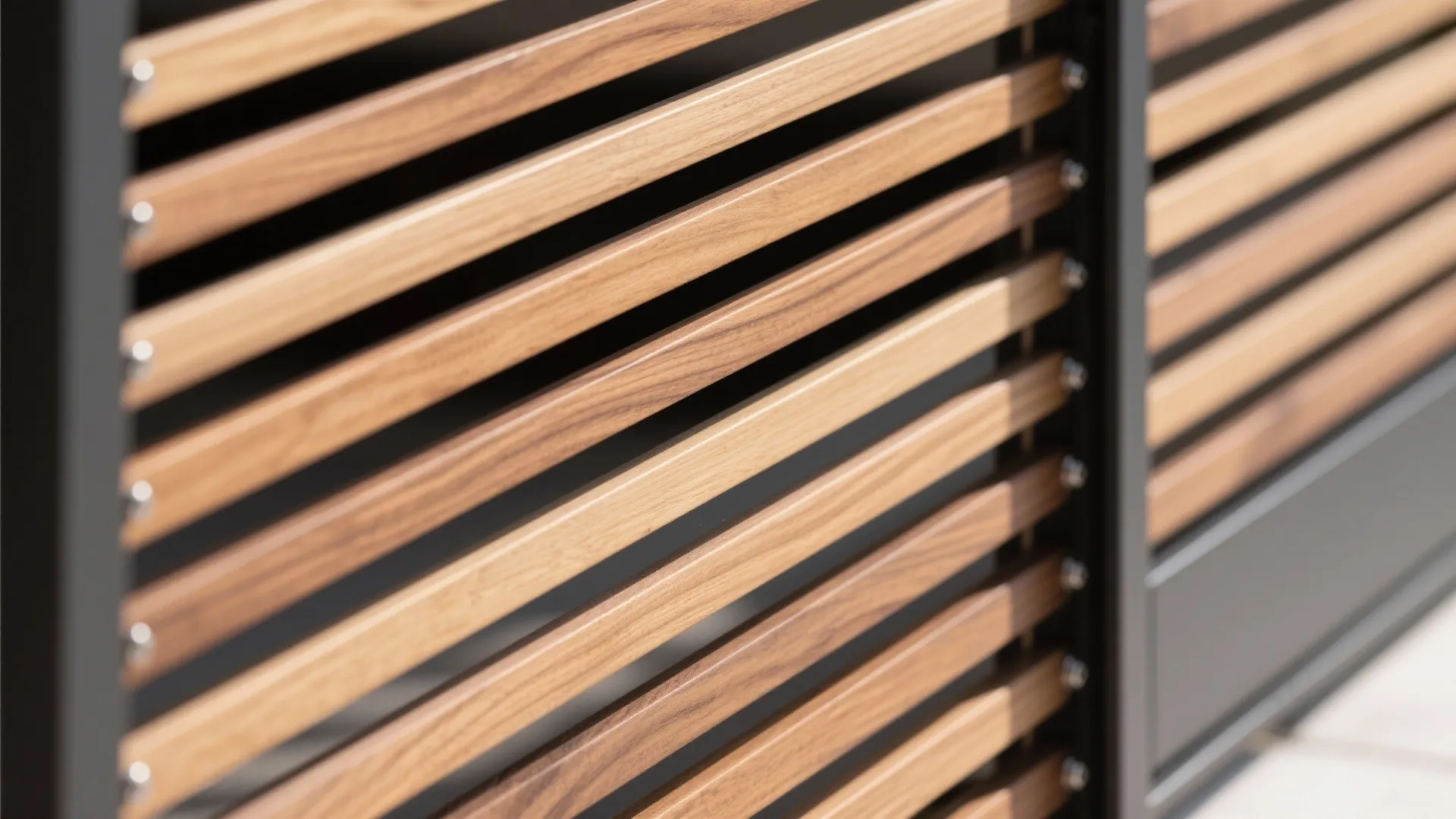 Close up shot of modern horizontal wooden fence slats with metal frame and screw details