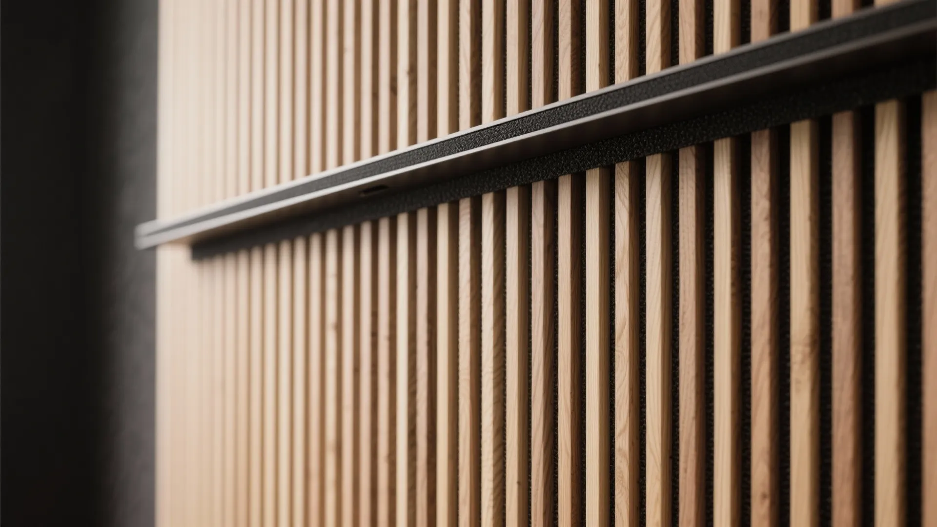 Close up view of vertical light wood wall panel texture with a black metal shelf