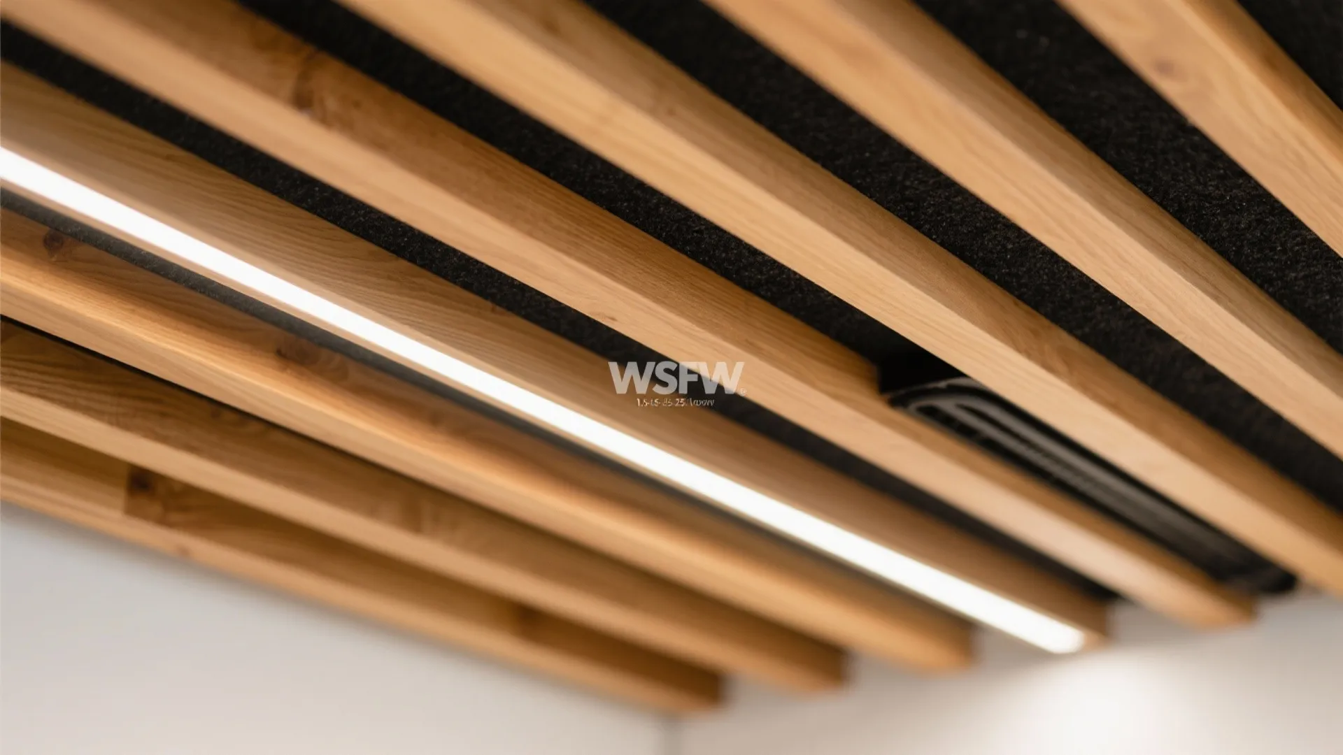Close up view of a modern ceiling with parallel wood slats and integrated bright strip light