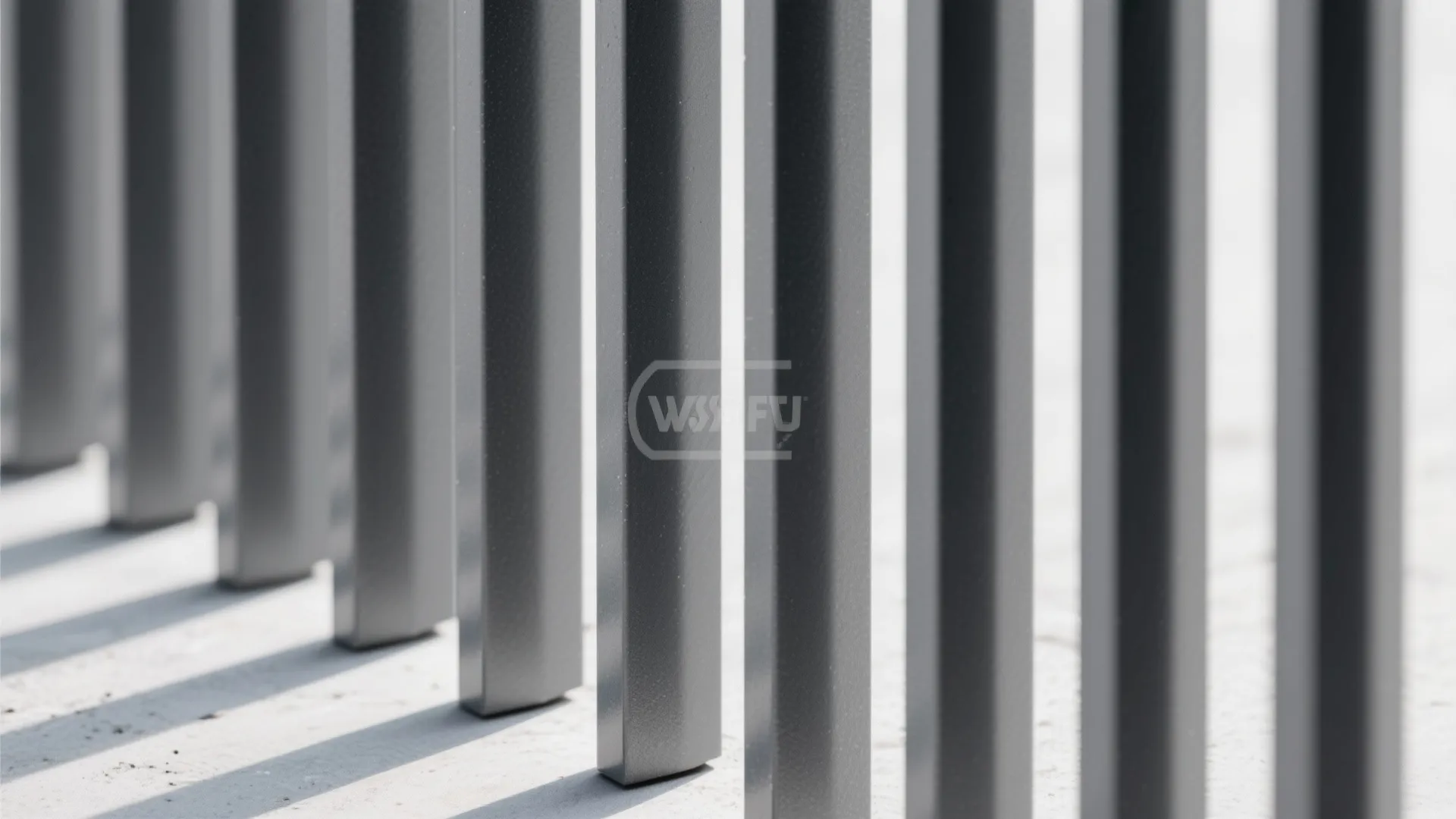 Close-up of matte powder-coated aluminum slats with precise spacing and crisp shadows.