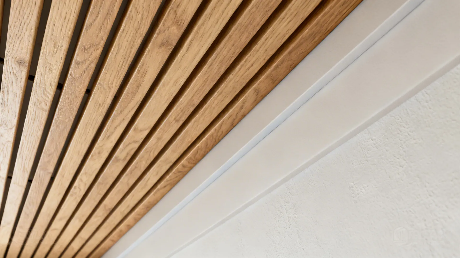 Close-up of oak ceiling slat and warm gray paint band with crisp edge.