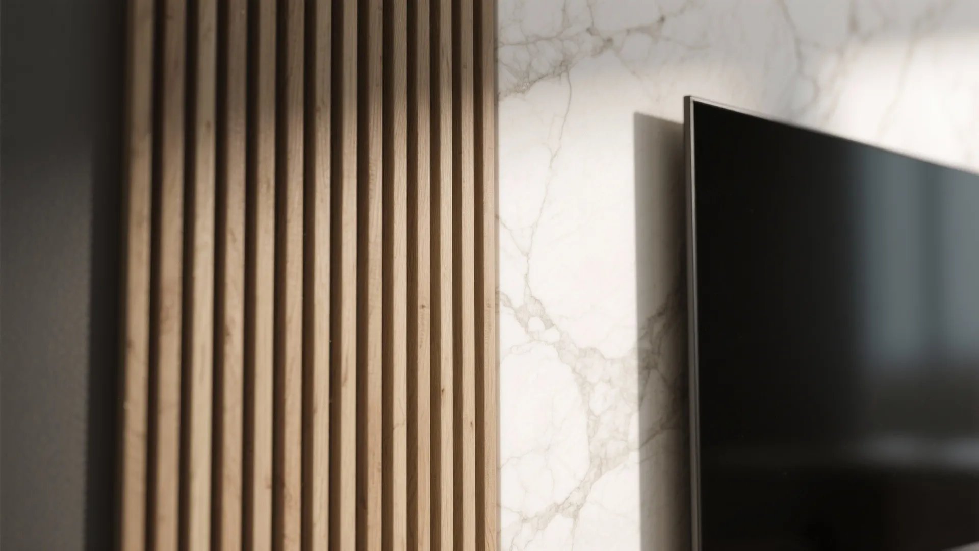 Close up view of vertical wood wall paneling next to white marble wall and black television